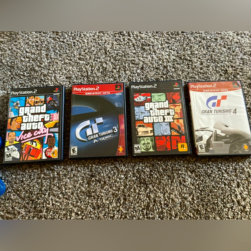 PS2 plus 4 controllers, 2 vintage game stop controllers, and 4 PS2 games